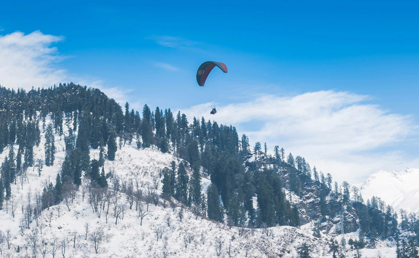 Paragliding over snow covered mountains of Himachal Pradesh